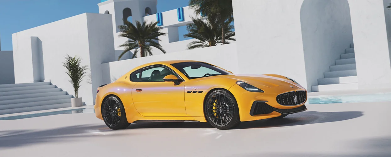 a front right view of a yellow Maserati GranTurismo Folgore EV