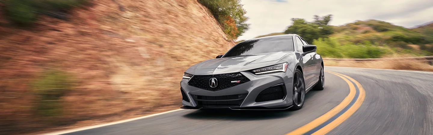 2025 Acura TLX gery driving on mountain