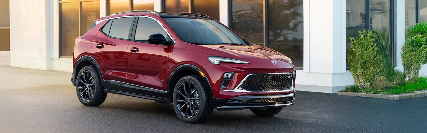 2025 Buick Encore GX red color car parked beside the house