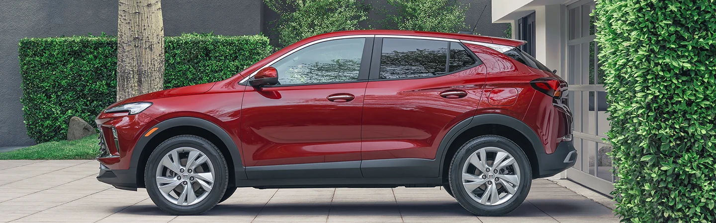2025 Buick Encore GX red color car parked beside the house