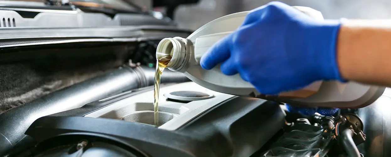 pouring oil into crankcase