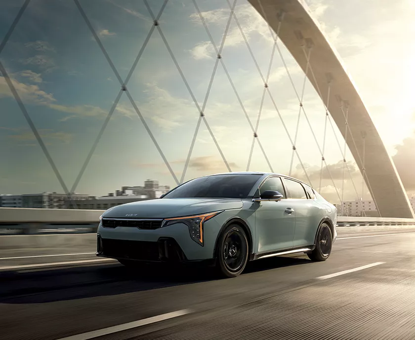 2026 Kia K4 driving on a bridge