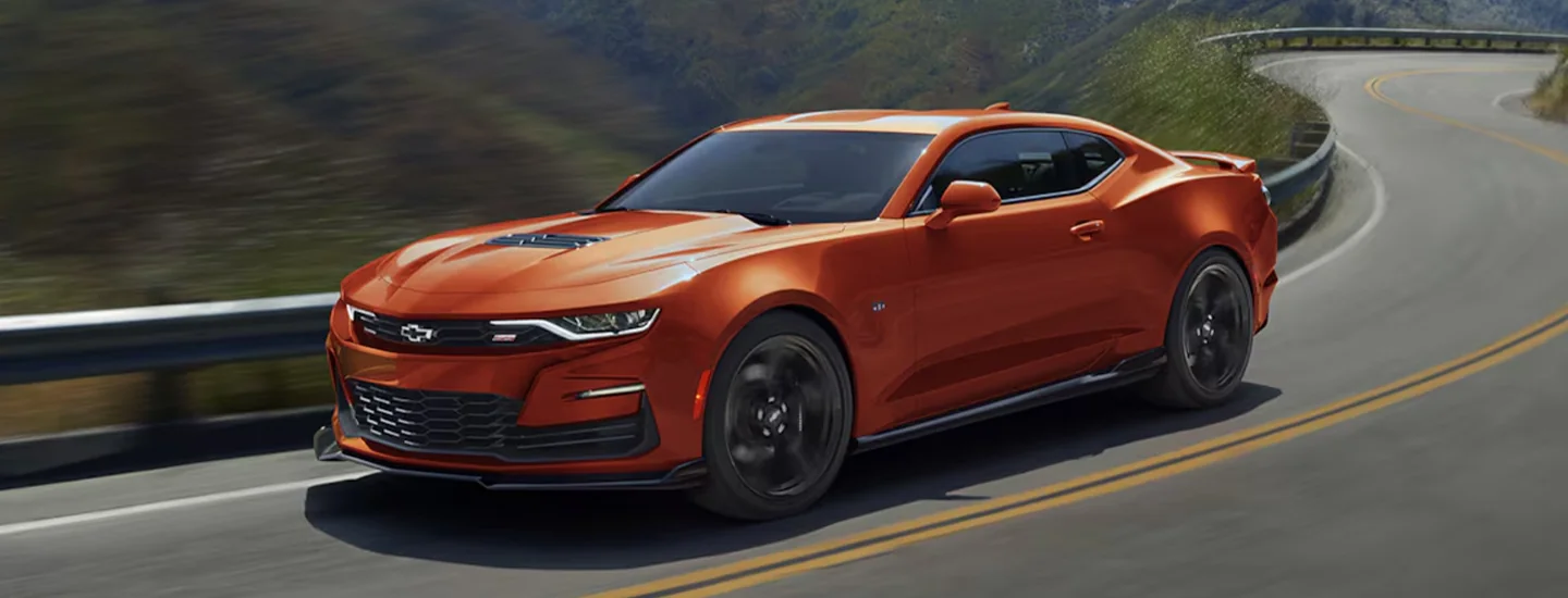 Orange 2024 Chevrolet Camaro driving on a road