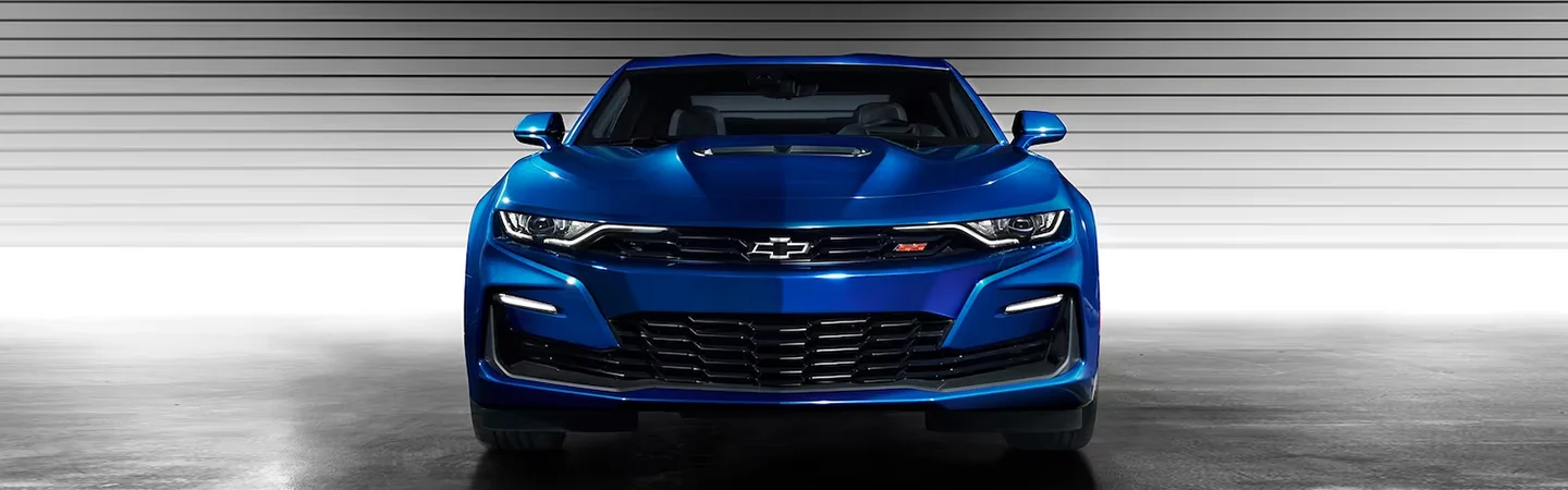 Front view of a blue 2024 Chevrolet Camaro parked in a studio