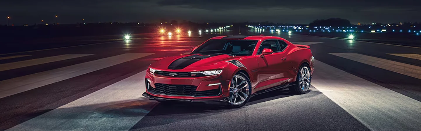 Red 2024 Chevrolet Camaro parked on an airport runway