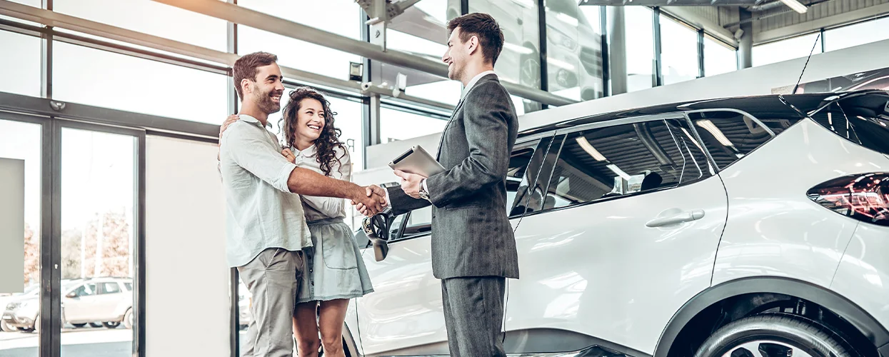 Sales person shaking hands with customers