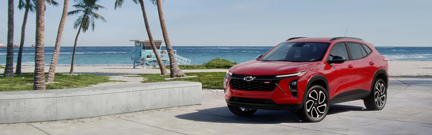 Red 2025 Chevrolet Trax parked at the beach
