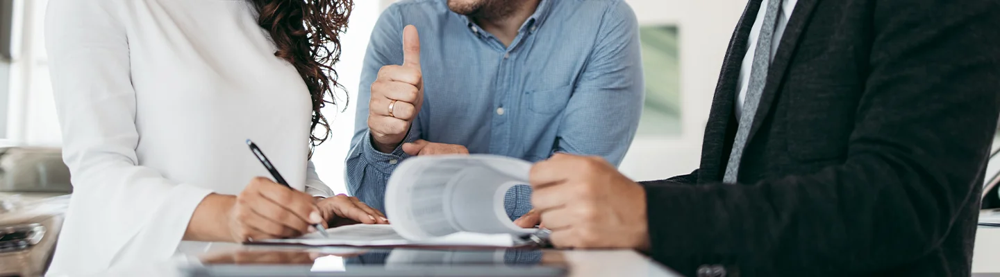 Customers signing a contract to buy a car