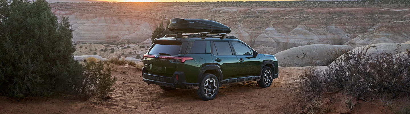 A back side view of a green 2026 Subaru Outback parked in the desert in Tyler TX