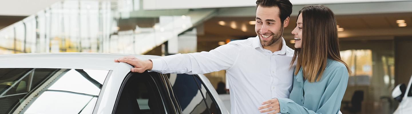 smiling couple in new car