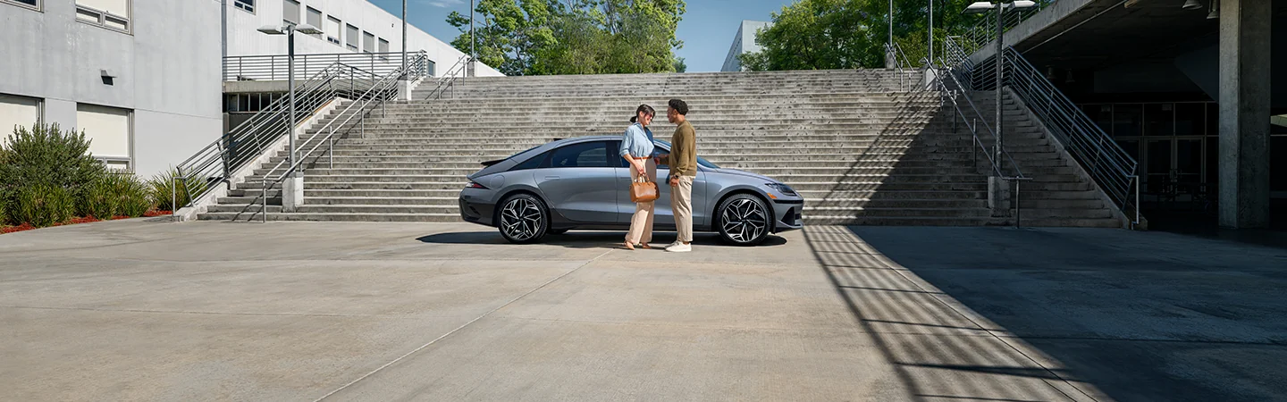 man and woman stand with gray 2025 Hyundai IONIQ 6 