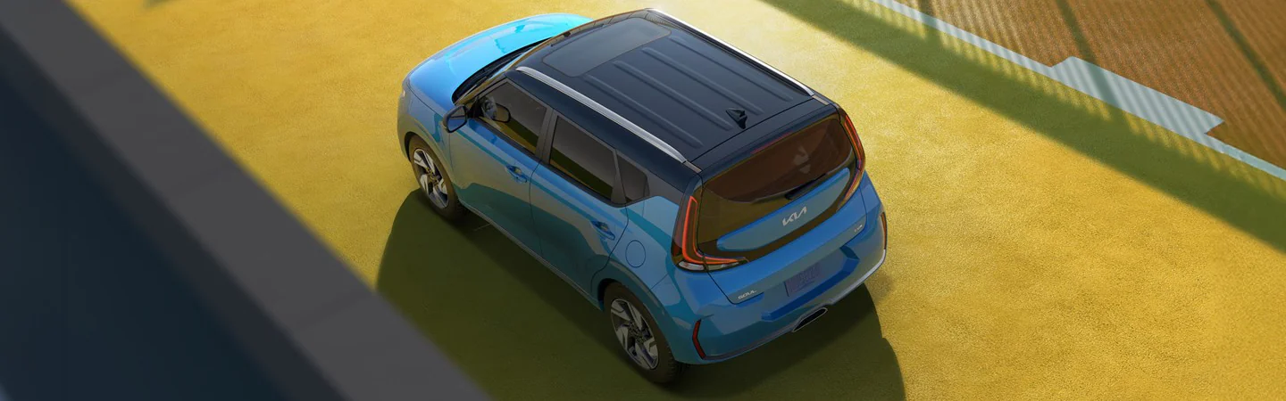 Top view of a parked blue 2025 Kia Soul on a yellow road