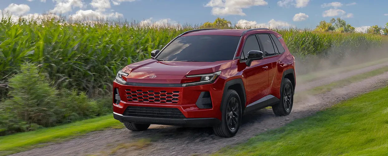 2026 Toyota RAV4 Hybrid driving past farm