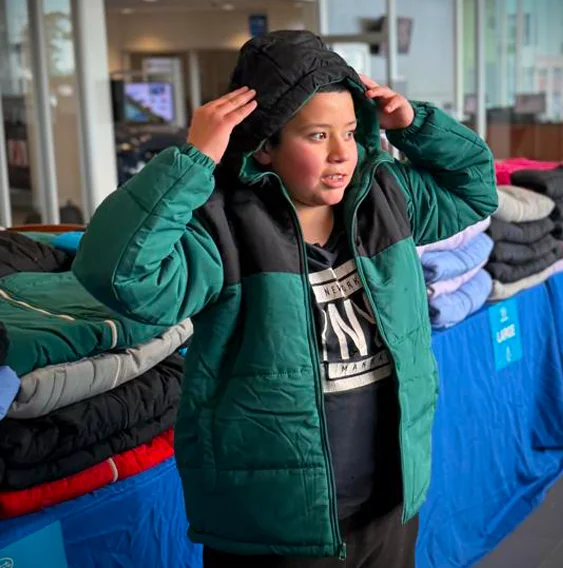 child trying on coat