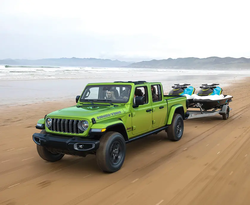 green Jeep Gladiator on beach