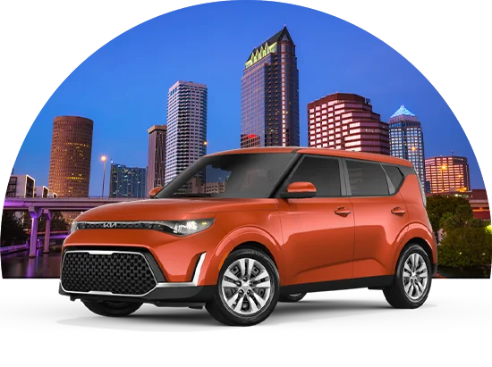 Orange Kia Soul with city skyline background