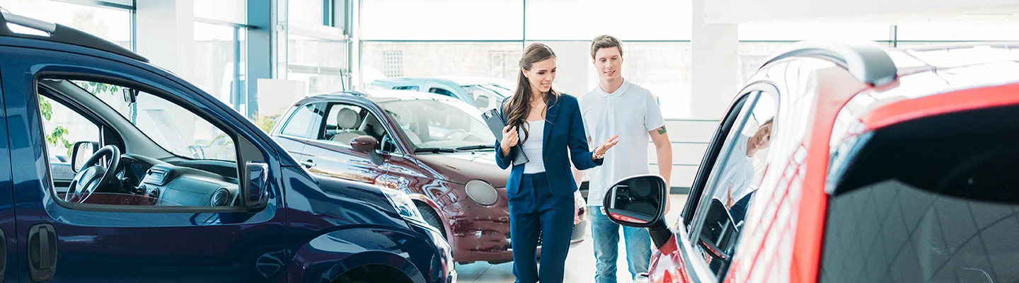 saleswoman showing a guy a new car