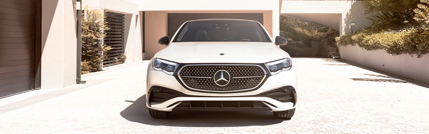 Front view of a parked 2025 Mercedes-Benz E-Class in a driveway