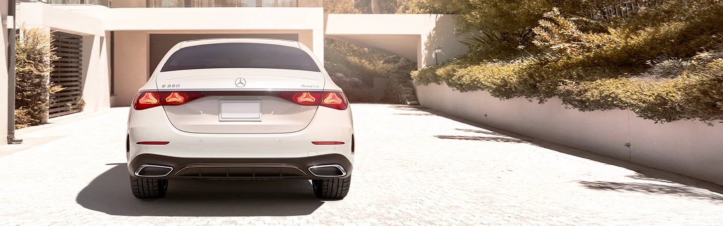 Back view of a parked 2025 Mercedes-Benz E-Class in a driveway