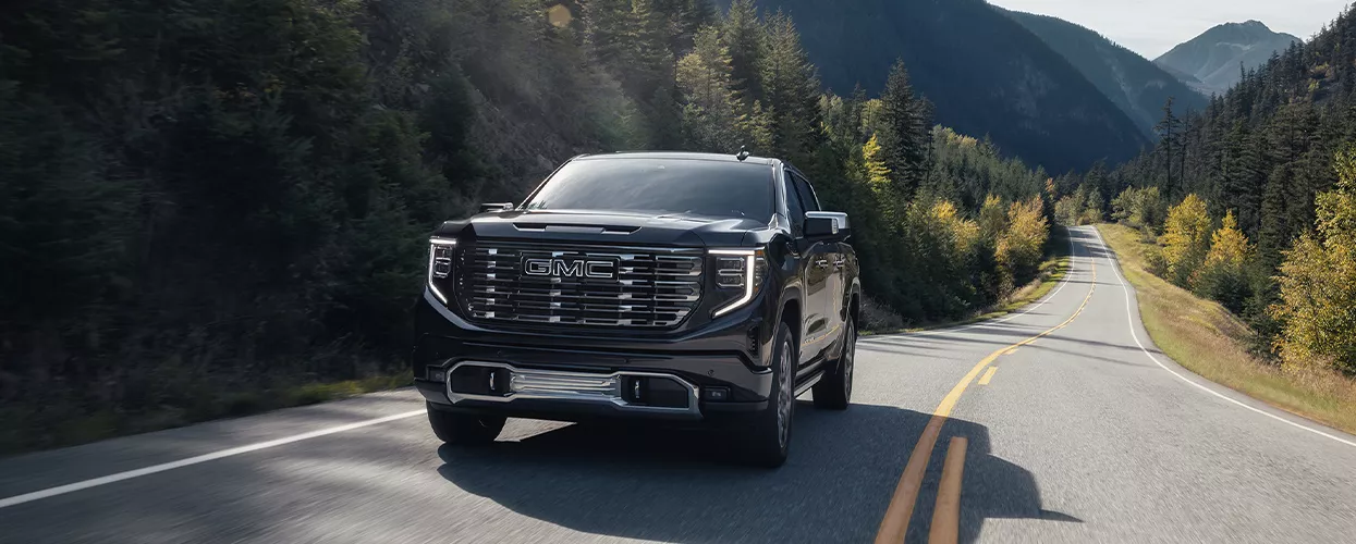 GMC Truck driving through mountains