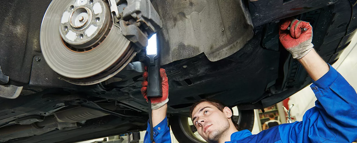Service tech checking out brakes