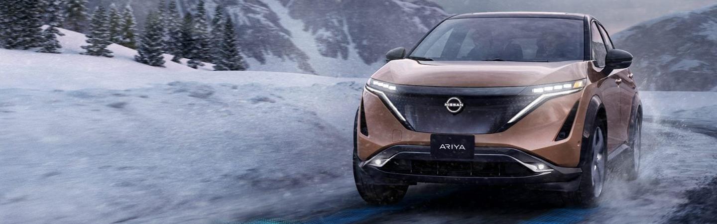 Front view of the 2022 Nissan Ariya driving in the snow