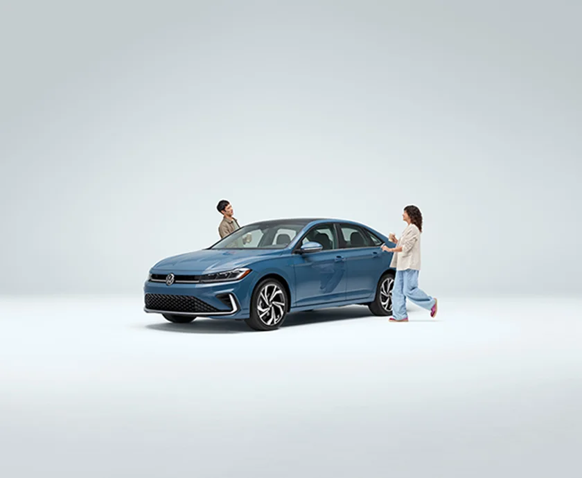 A couple walking up to there new 2026 Volkswagen Jetta