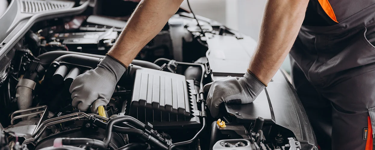 Kia service tech working on an engine