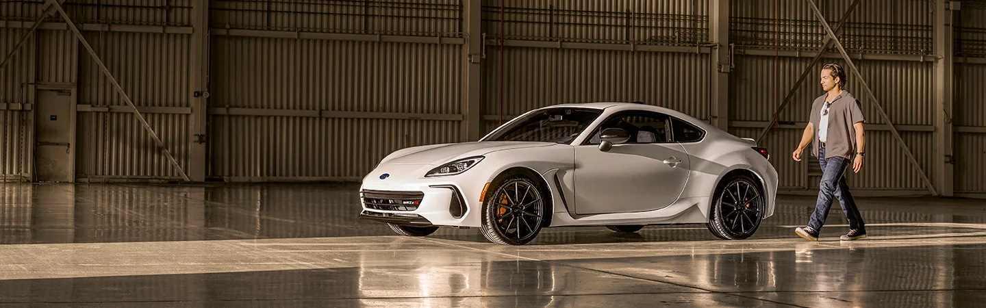 White 2025 Subaru BRZ parked in a wearhouse with a man walking to the car in Chattanooga, TN.