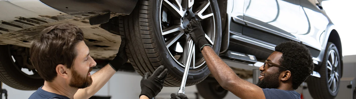Mechanic changing a tire on a vehicle