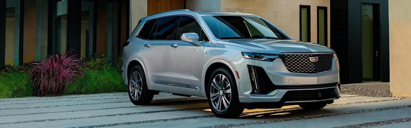 Angled profile of a parked silver Cadillac XT6