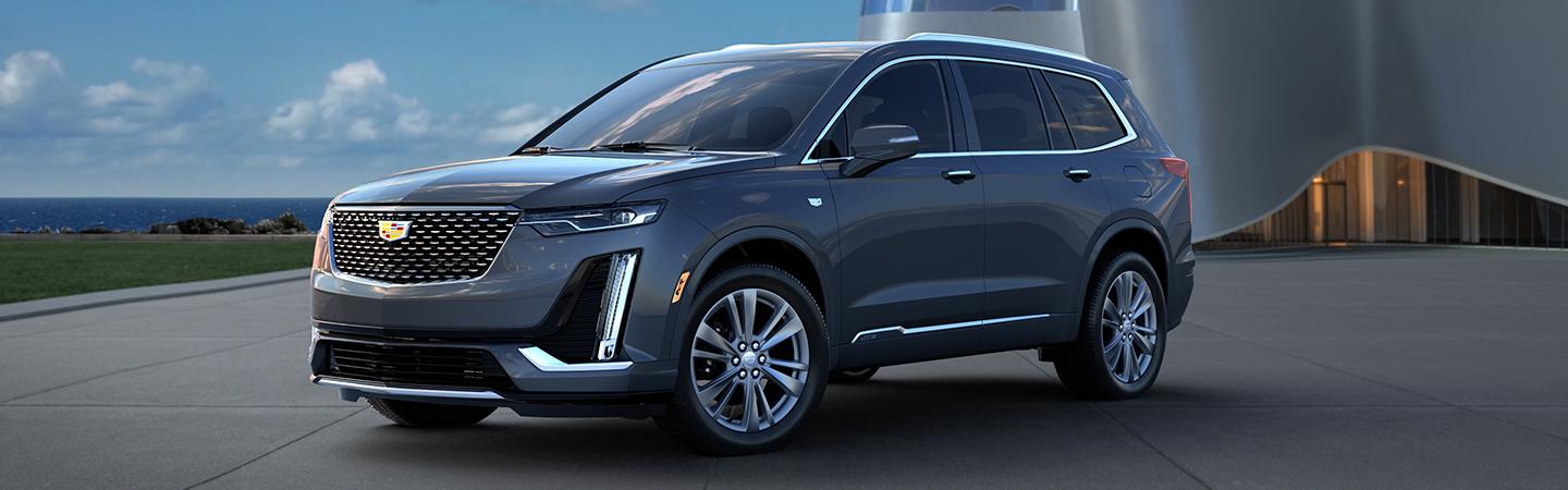 Angled profile of a parked gray Cadillac XT6