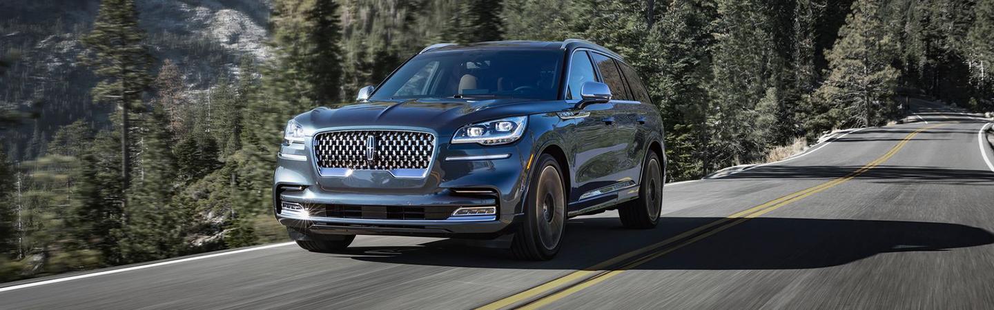 Angled front profile of a gray Lincoln Aviator in motion