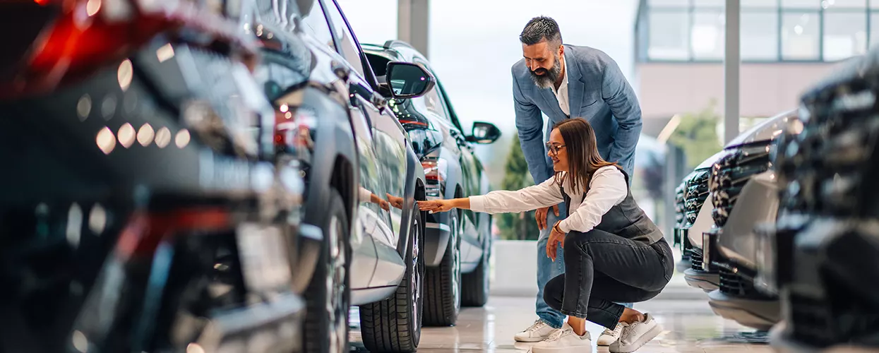 Car salesman talking to a customer about a new vehicle