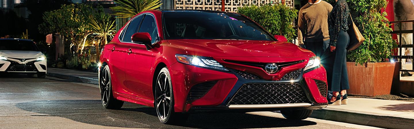 Red 2020 Toyota Camry parked on a city street