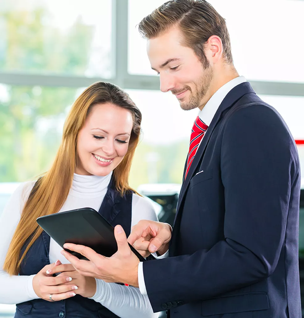 salesman showing woman information on a tablet