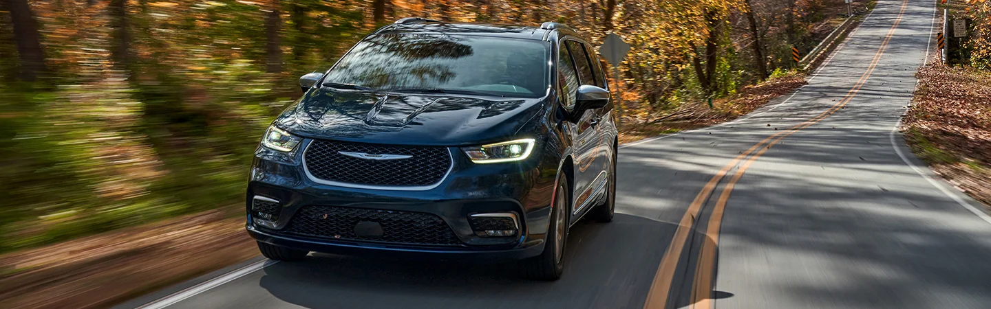 2025 Chrysler Pacifica Specs blue color man drive a car on road