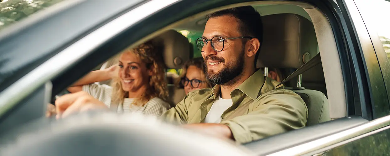 smiling family in new car