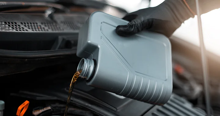 Oil being added to a vehicle