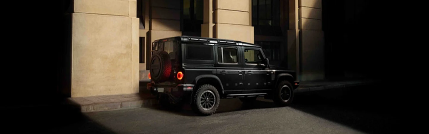 dark INEOS on street parked