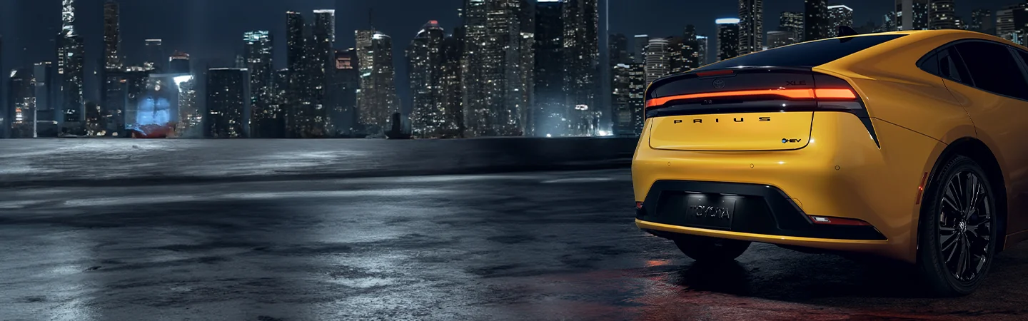 just part of a rear of a 2025 Toyota Prius LE parked with a skyline view