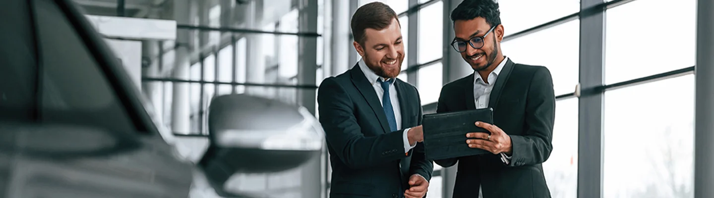 sales agents going over car info on tablet