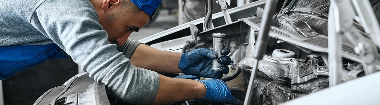 A technician performing work on an engine