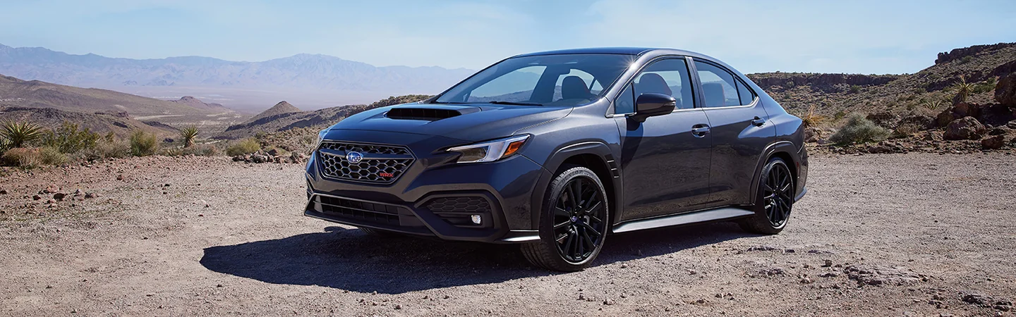 Side view of a gray 2025 Subaru WRX parked in the desert
