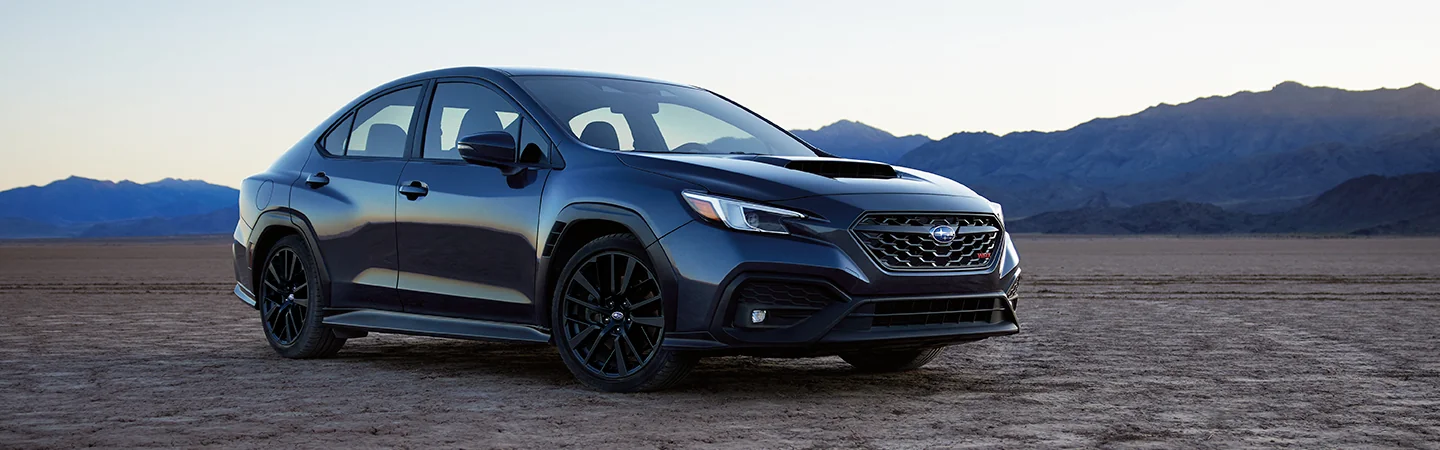 Front side view of a gray 2025 Subaru WRX parked in the desert