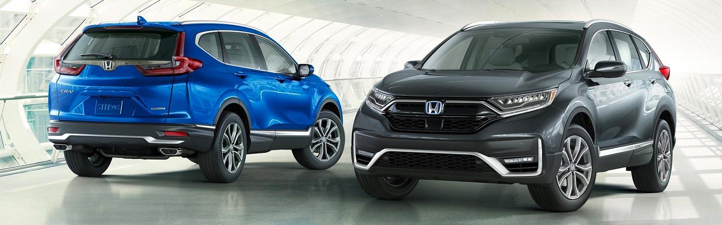 Blue and gray Honda SUV parked side by side