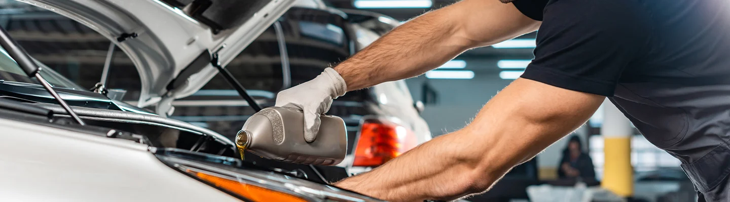 tech adding oil to engine