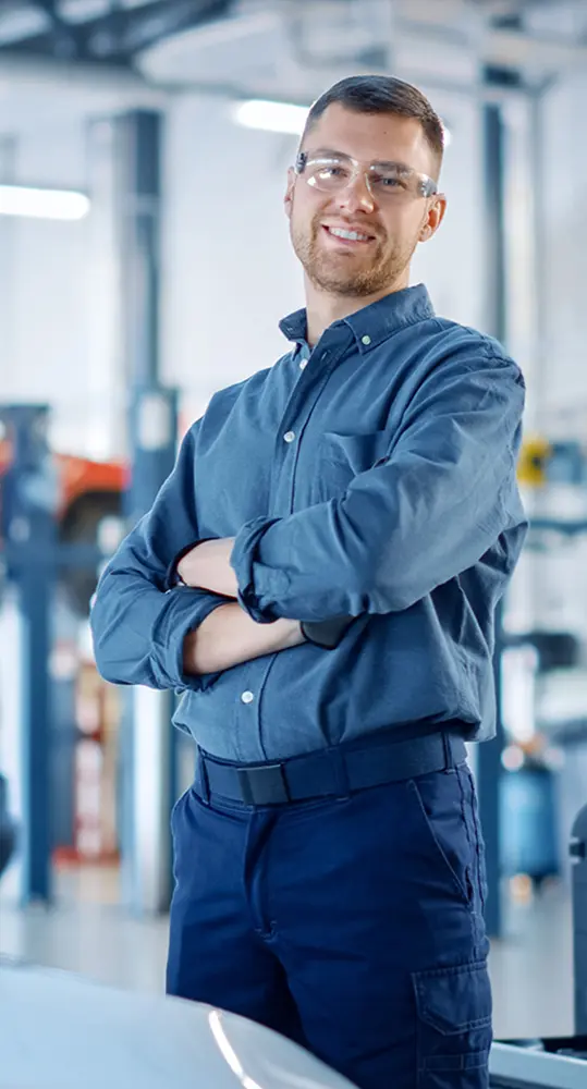 smiling service techician standing in repair bay at Charlotte Lamorghini