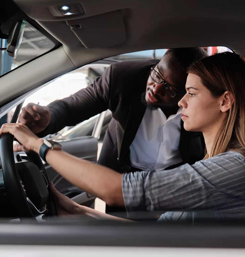 Sales person showing the inside of a new Subaru