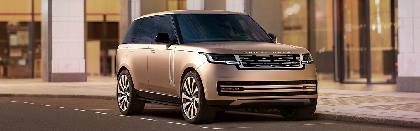 golden 2025 Range Rover parked on raod